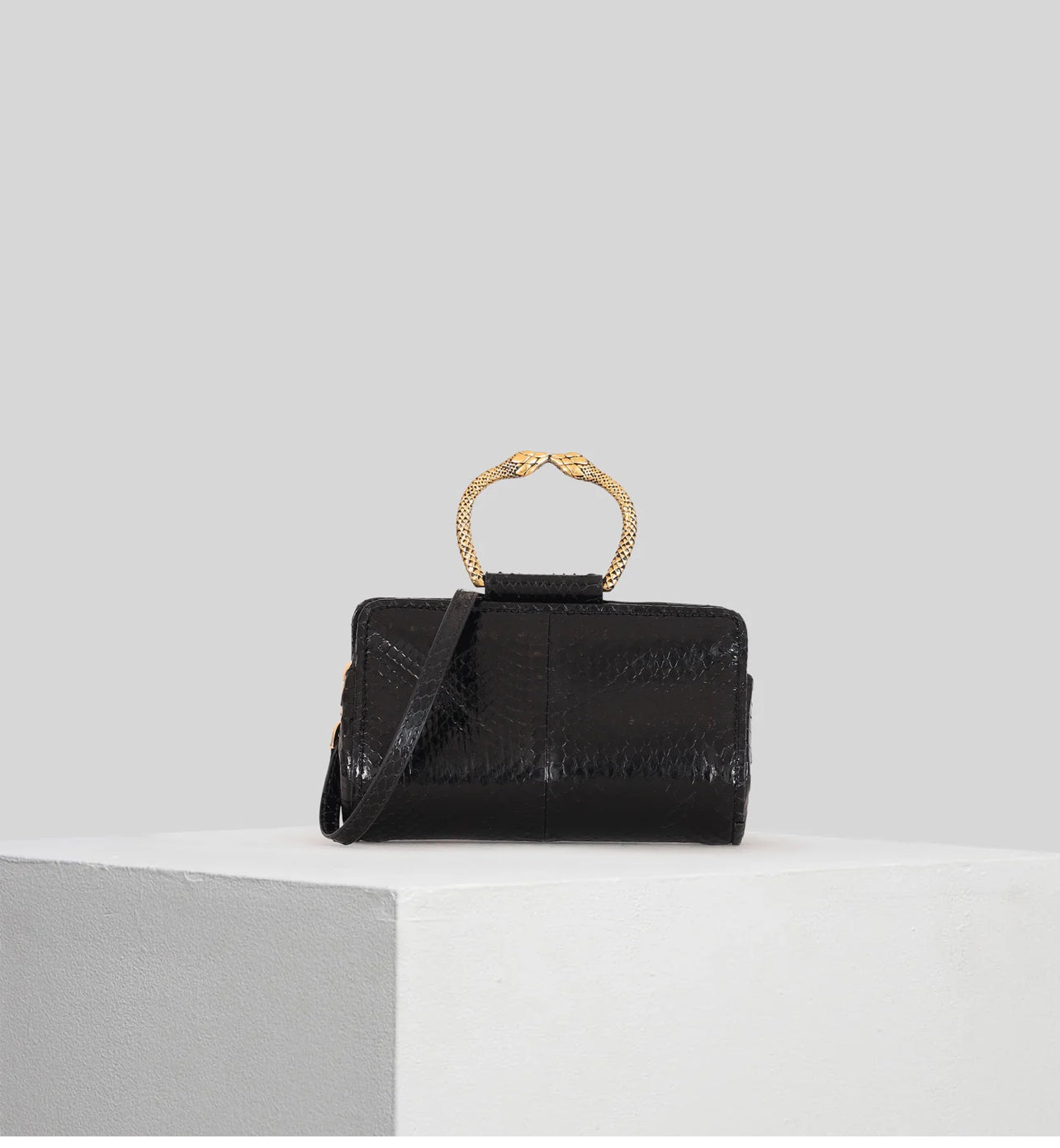 Tramontano clutch in pelle di serpente nera con bracciale in ottone e tracollina removibile