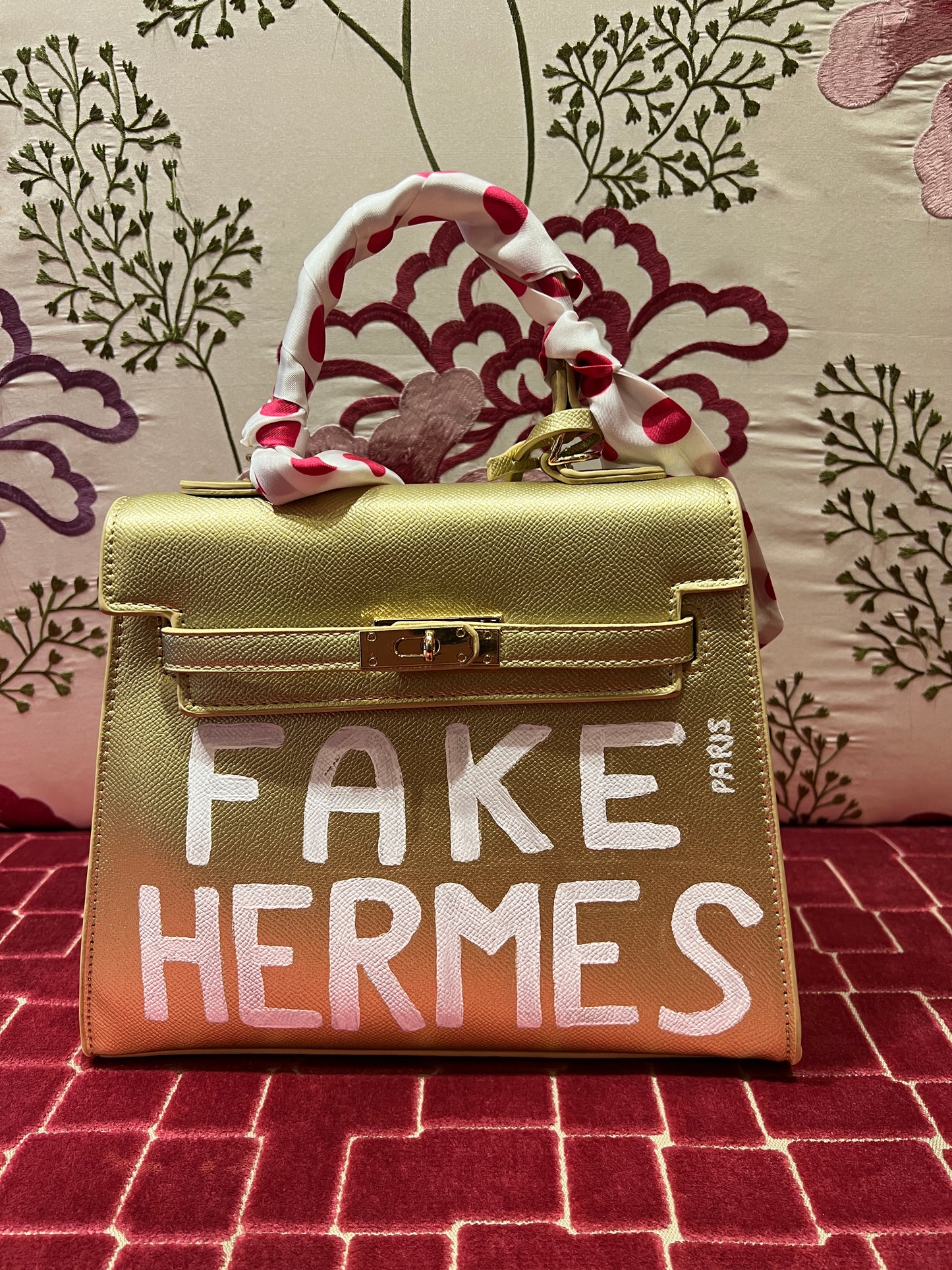 Borsa oro dipinta a mano con scritta “ Fake Hermes “ bianca con tracollina