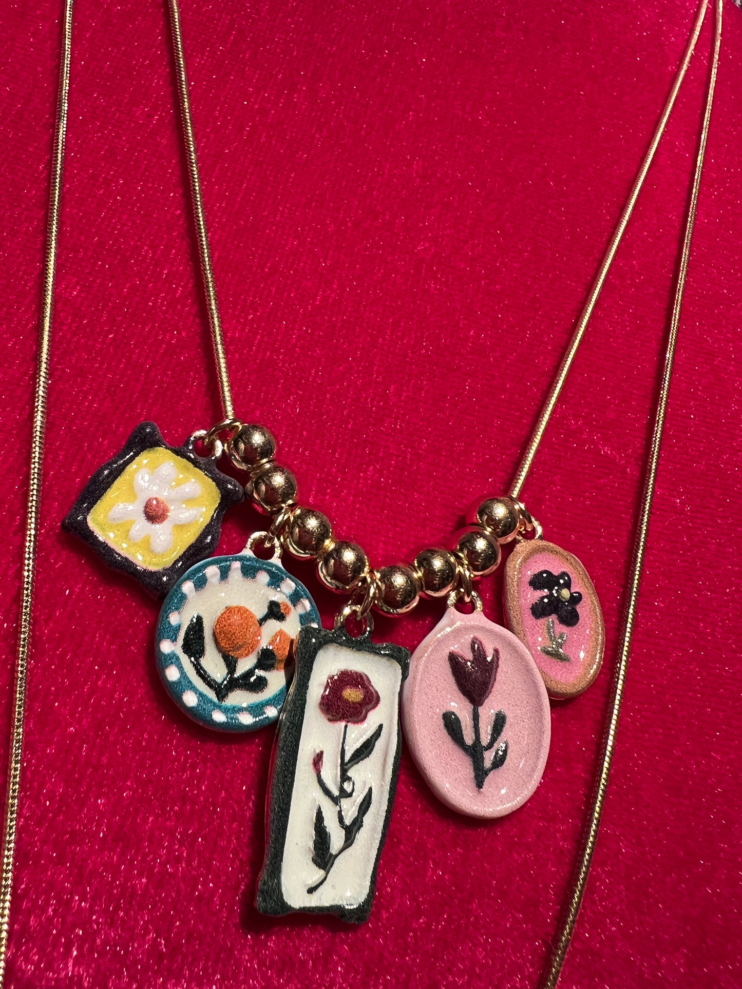 Collana composta da due collanine dorate con mattonelle colorate con i fiori