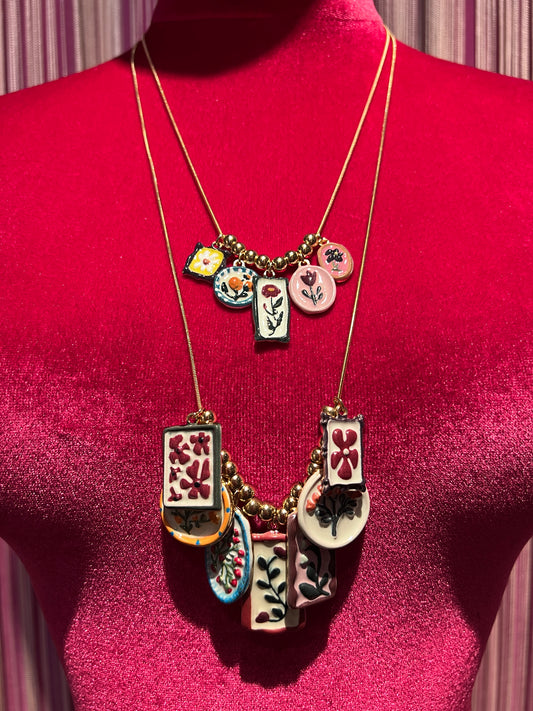 Collana composta da due collanine dorate con mattonelle colorate con i fiori