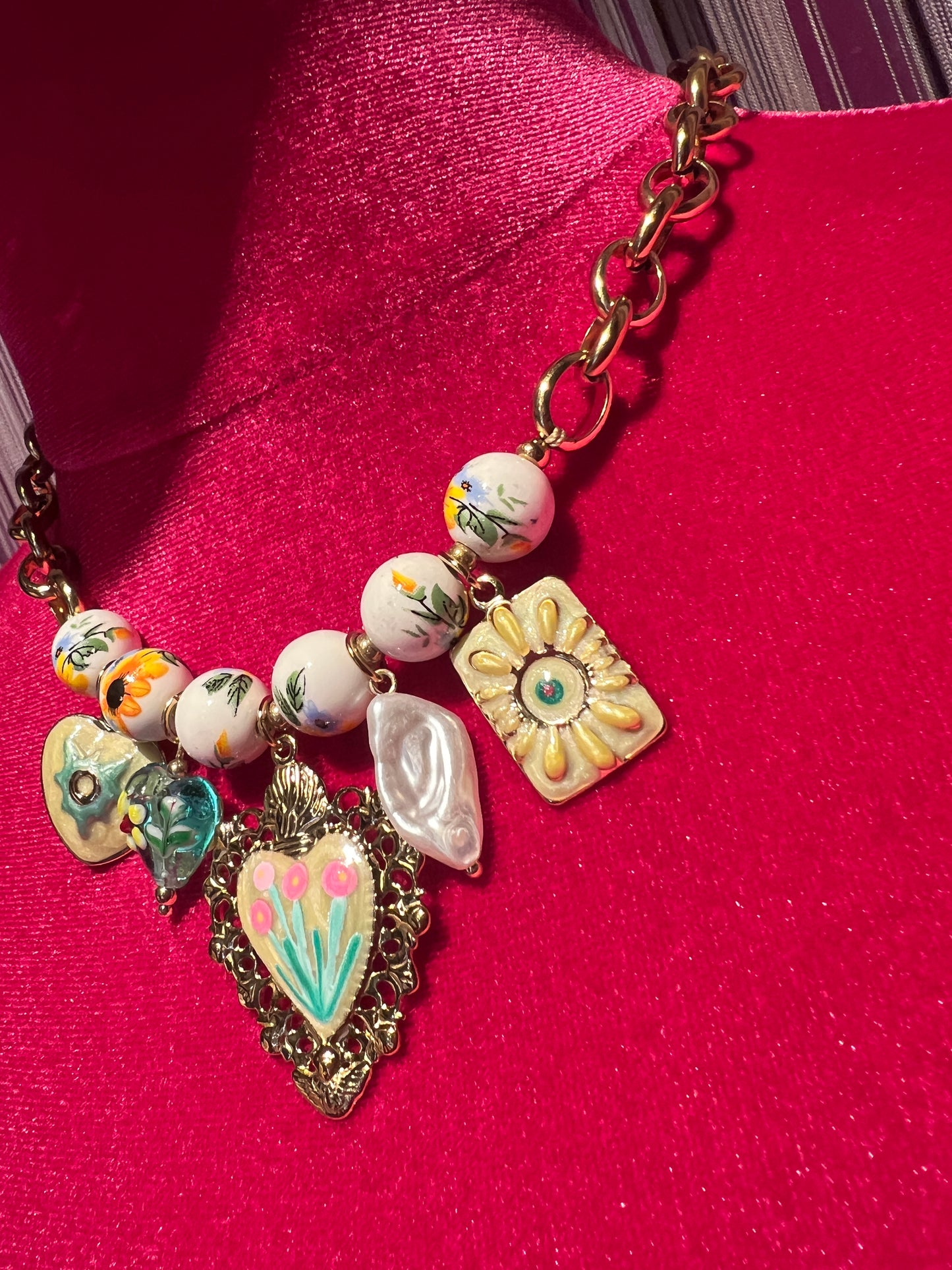 Collana girocollo dorata con perle disegni floreali , cuore sacro smaltato e charms