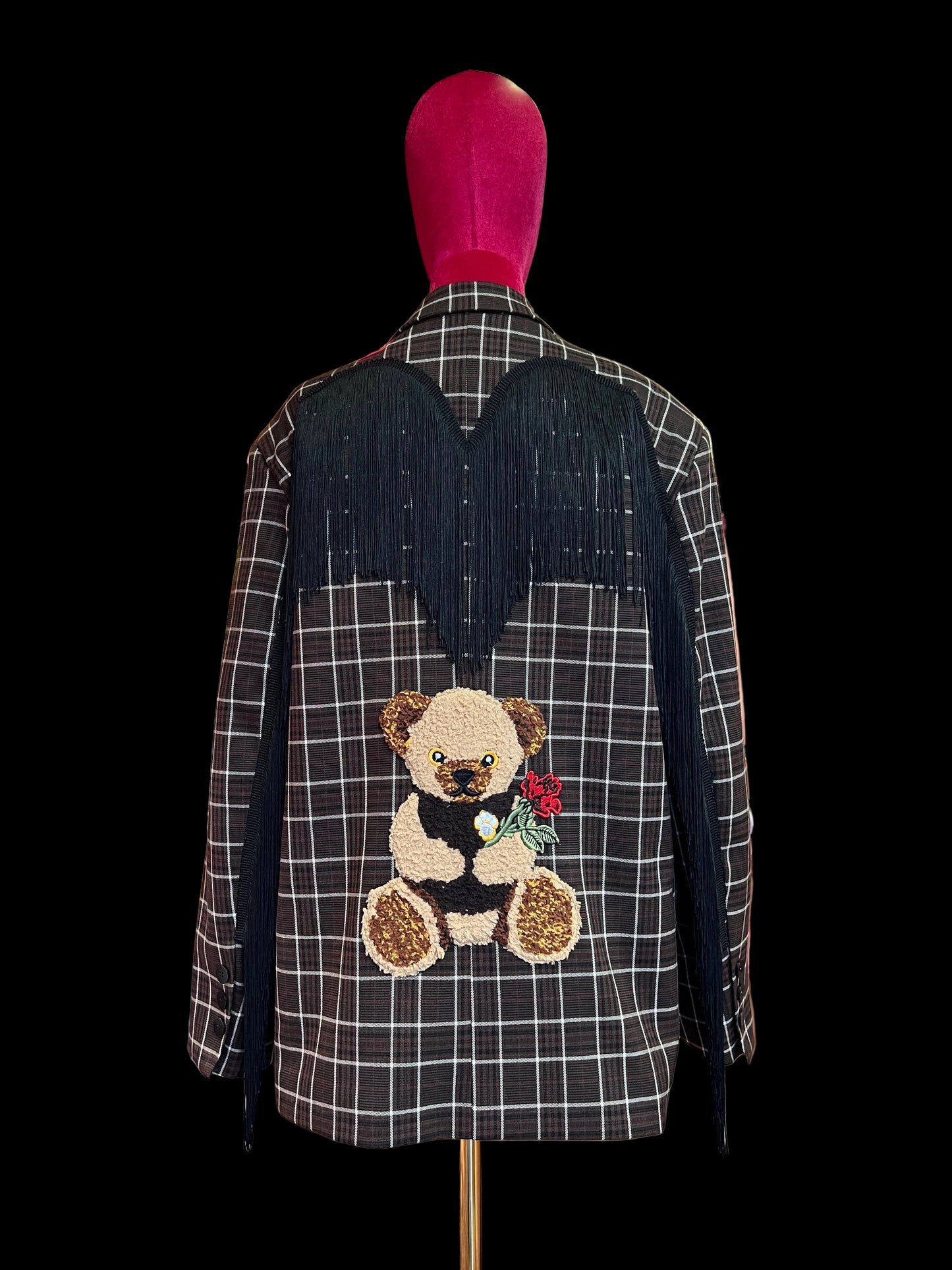 The room giacca tartan marrone panna con frange nere e patch orso dietro