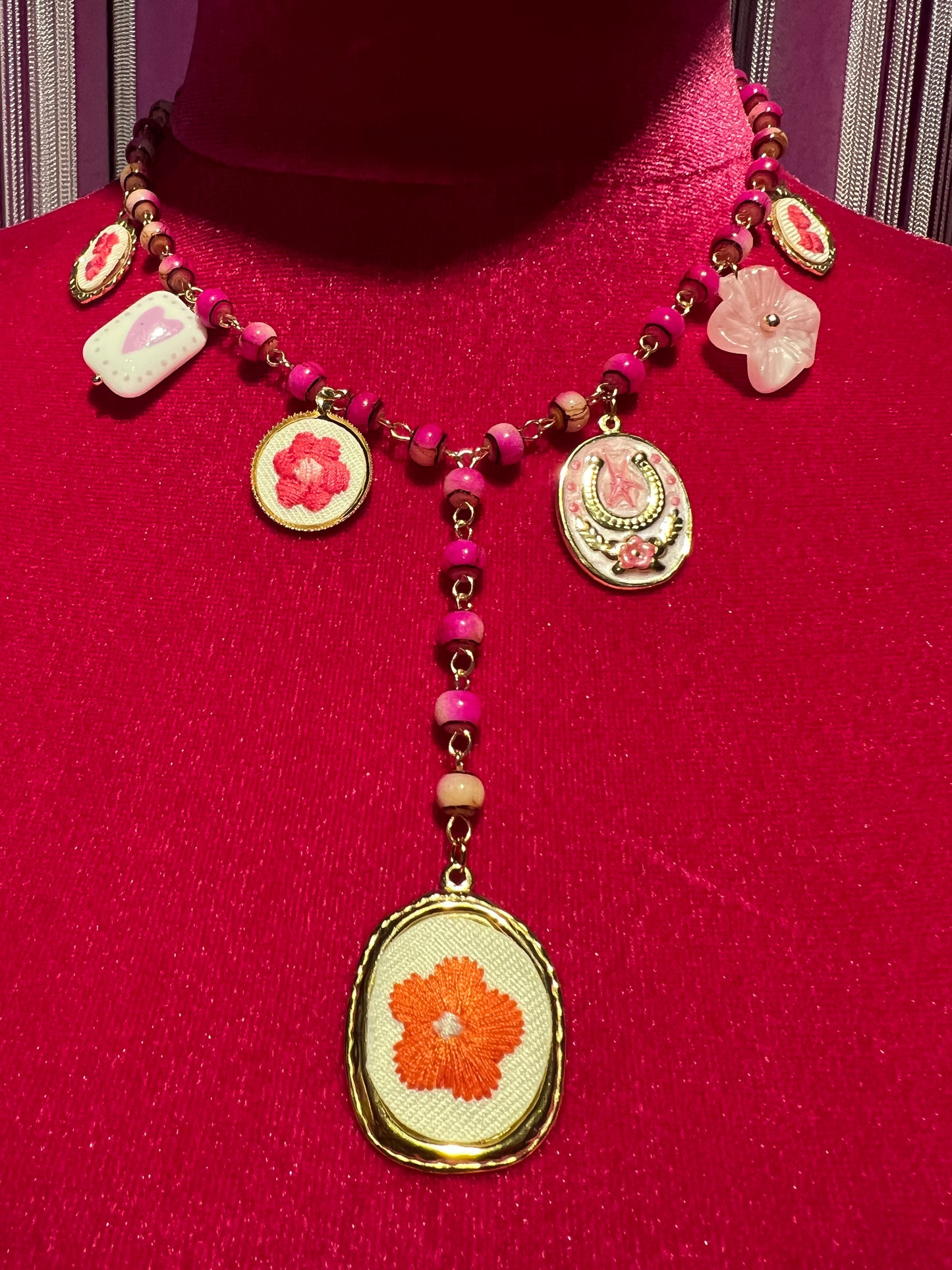 Collana con perline fucsia montatura a rosario con ciondolo fiore ricamato e charms